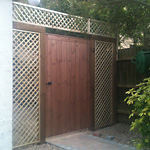 Tongue and grove gate surround by lattice privacy panels